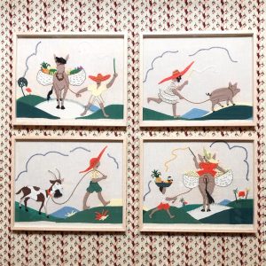 Four wooden framed embroidered cotton folk art pictures